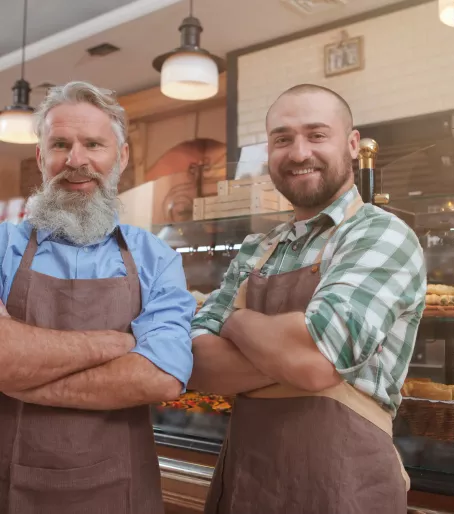 Pai e filho na padaria de braços cruzados
